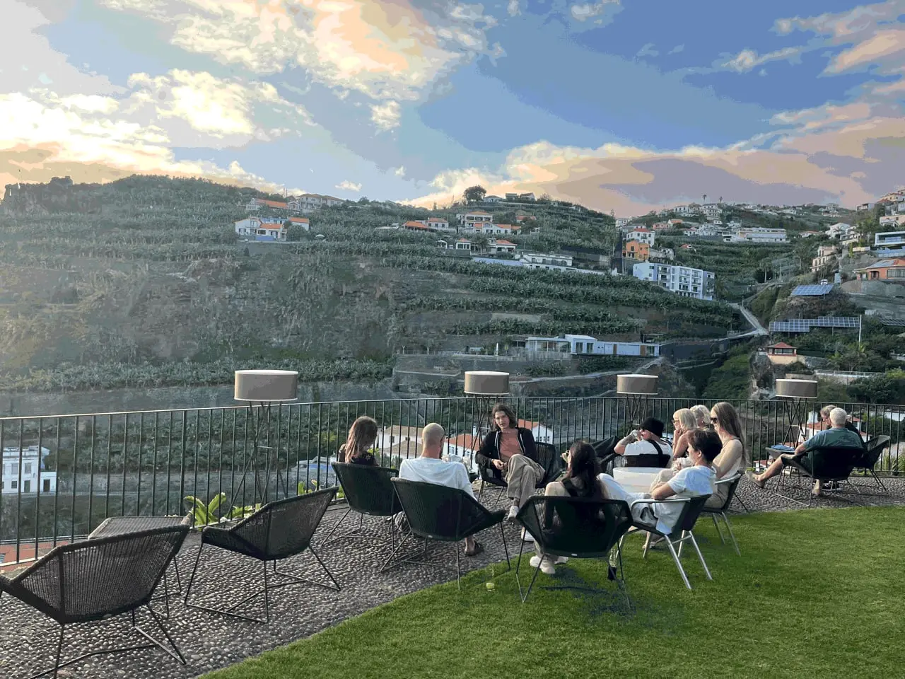 Group sitting on a lawn above Funchal at sunset