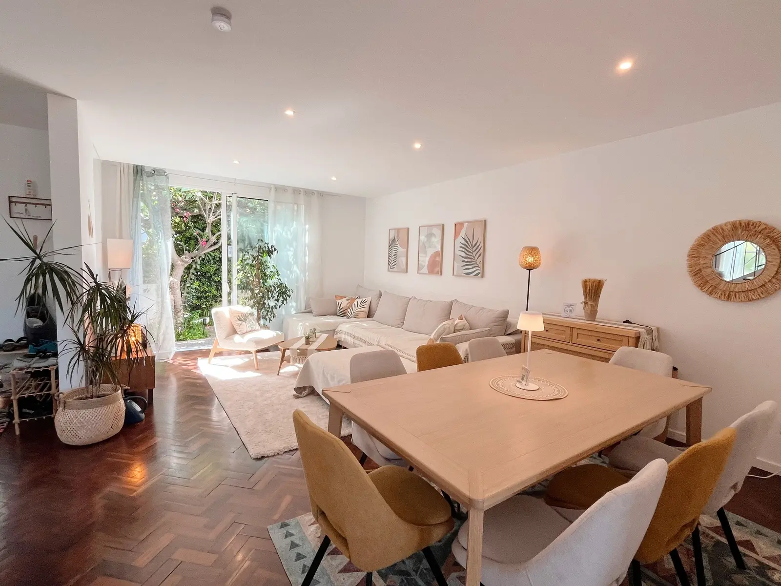 Open living and dining room with a large table and garden doors